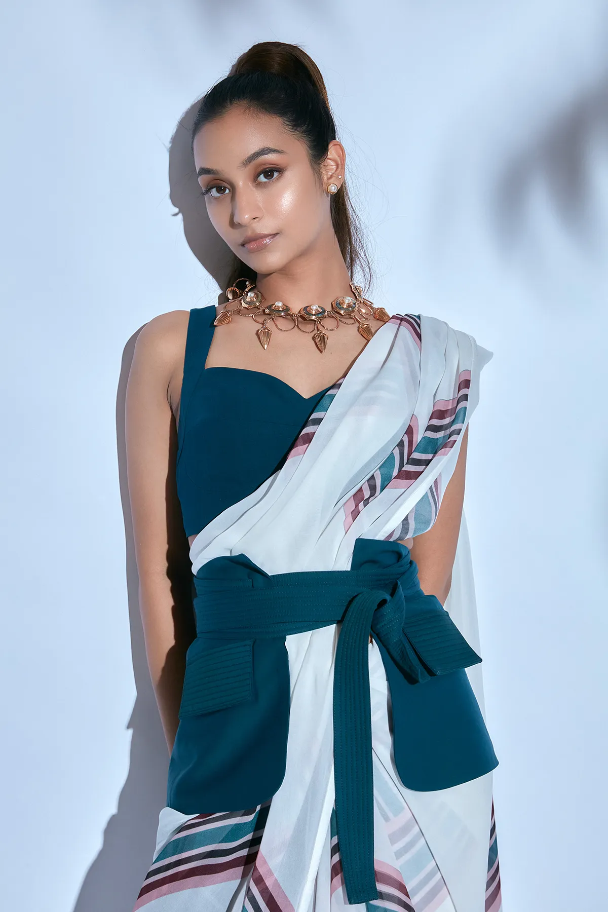 White Printed Sari paired with Teal Blouse