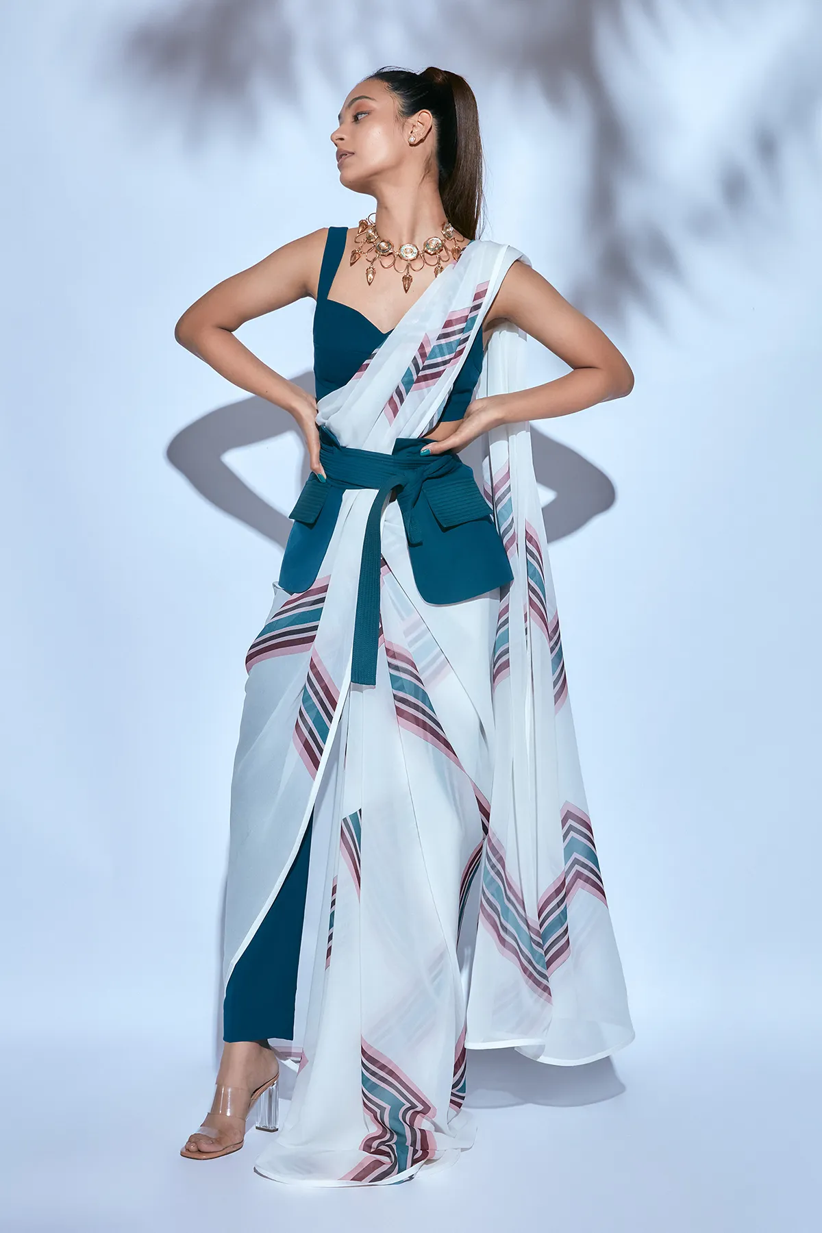 White Printed Sari paired with Teal Blouse